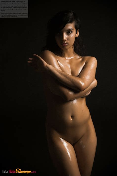 naked indian female exposes a single breast while modeling in the dark