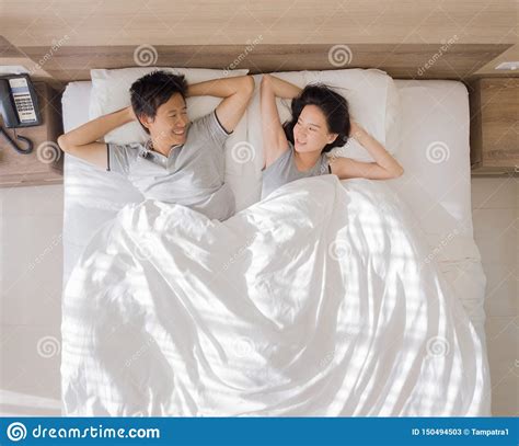 top view of happy asian couple smiling and sleeping