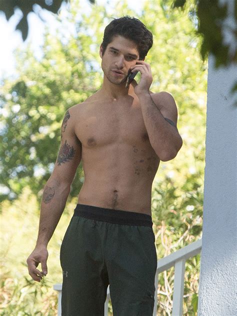 tyler posey is shirtless as he smokes a cigarette and cleans out garage