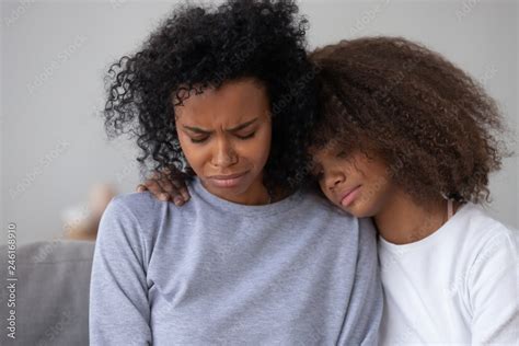 African American Teenage Daughter Hug Sad Depressed Mom Crying Having