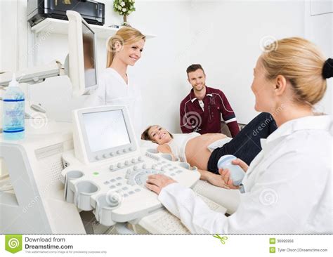 gynecologists and expectant couple in clinic