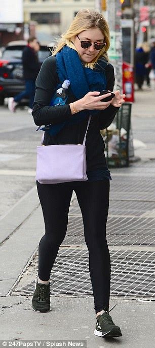 dakota fanning shivers as she goes without a coat for gym trip in