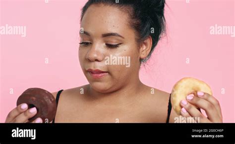 Cute Curvy Black Girl Eating Donuts Stock Video Footage Alamy