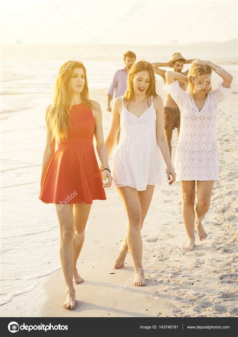 friends walking  beach stock photo  juripozzi