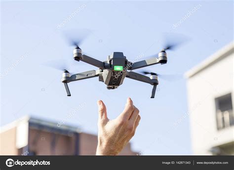 black drone lands   hands  technician stock photo image   marinobocelligmailcom