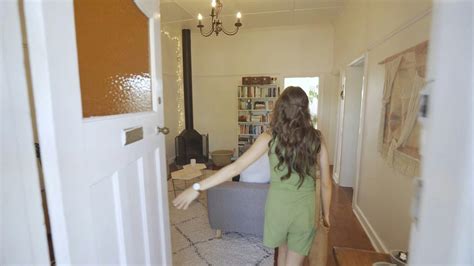 woman entering  living room  stock video