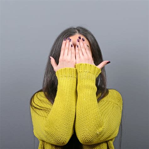 portrait  woman hiding  face   hands  gray background stock photo image