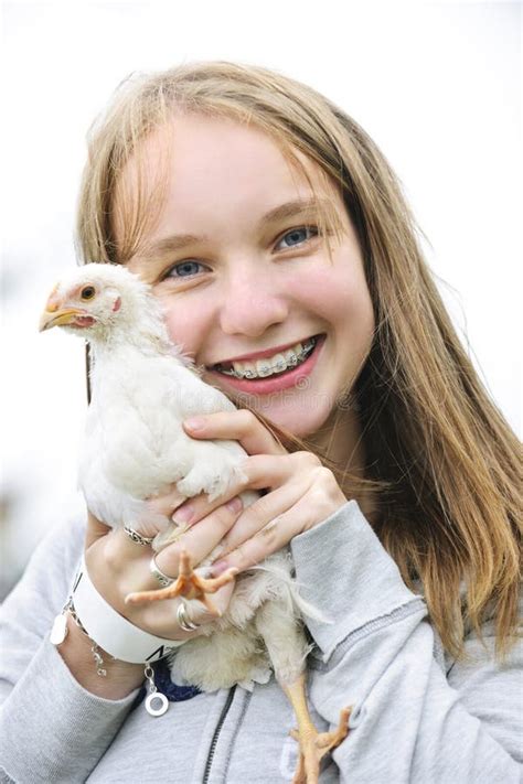 teenage girl holding chicken stock image image  biodynamic blonde