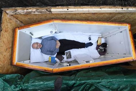 man is buried alive in coffin under city street after kissing his wife
