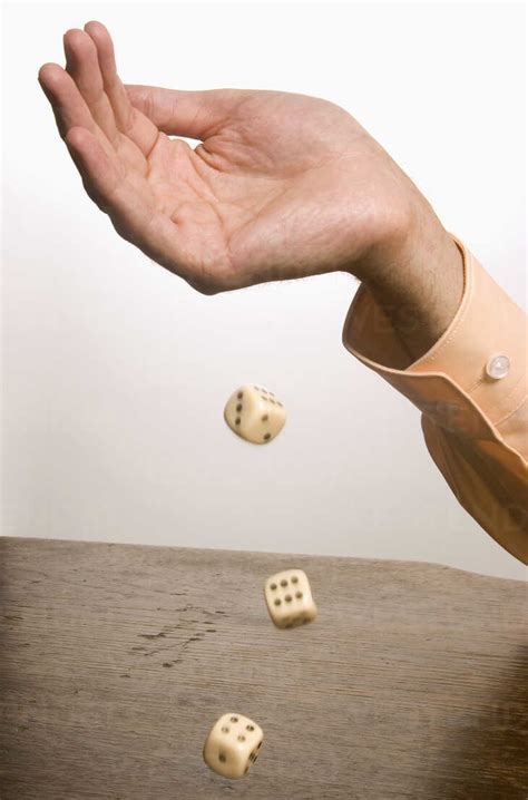 human hand throwing dice close  stock photo