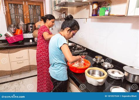 Indian Asian Mother And Daughter Cooking Working In Kitchen Stock
