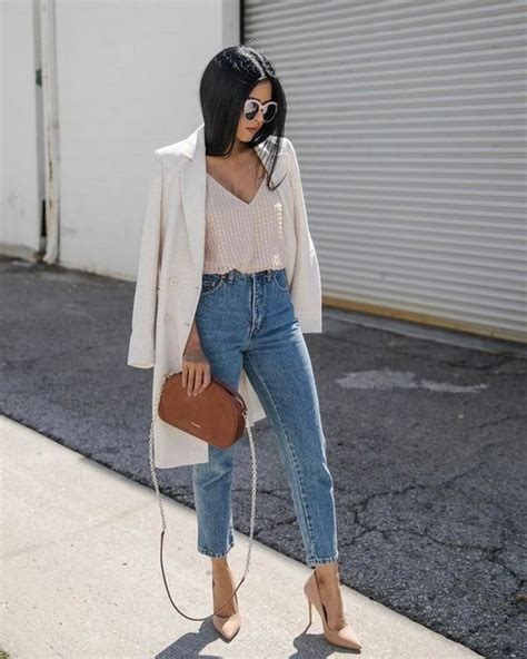 picture of blue mom jeans a blush top a creamy long blazer nude heels and a brown bag is a