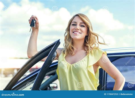 attractive woman standing   car holds  car key   hand