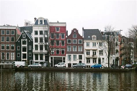 traditional dutch houses  canal  amsterdam netherlands  stocksy contributor duet