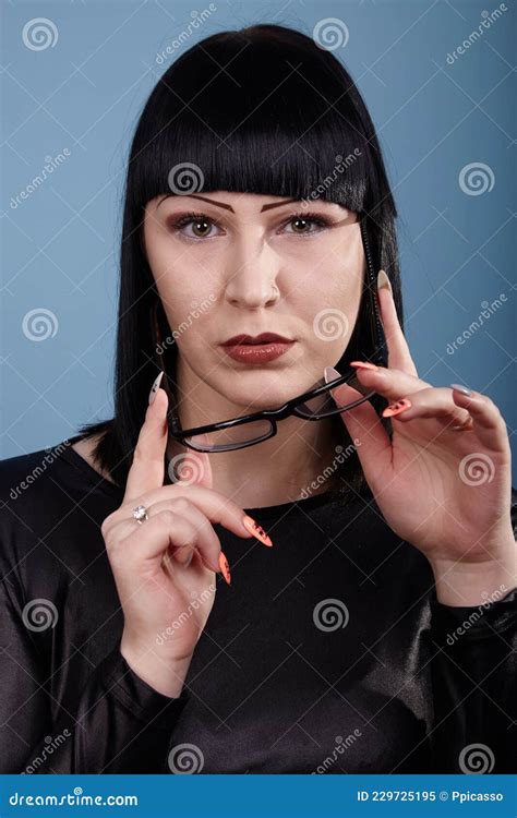 Portrait Of A Beautiful Girl With Glasses Posing For A Photographer In