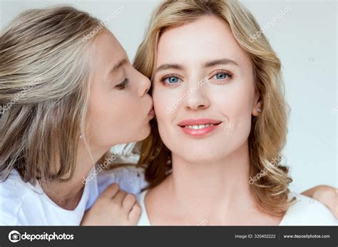 cute daughter kissing smiling attractive mother isolated grey — stock