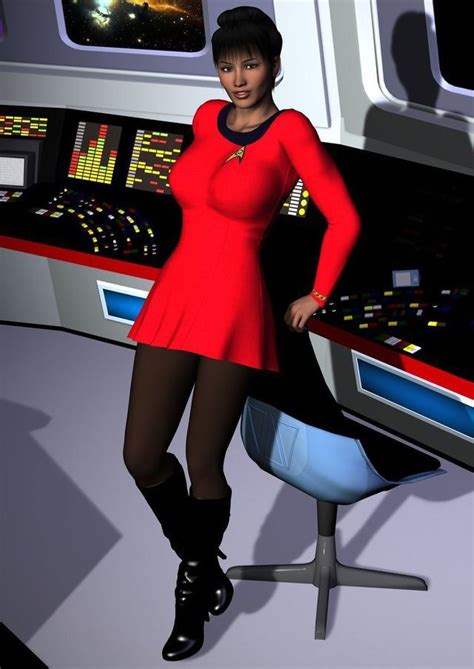 A Woman In A Red Dress Is Standing Next To A Computer Desk And Monitor