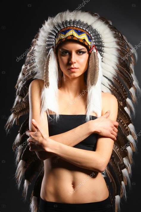 beautiful woman in native american costume with feathers