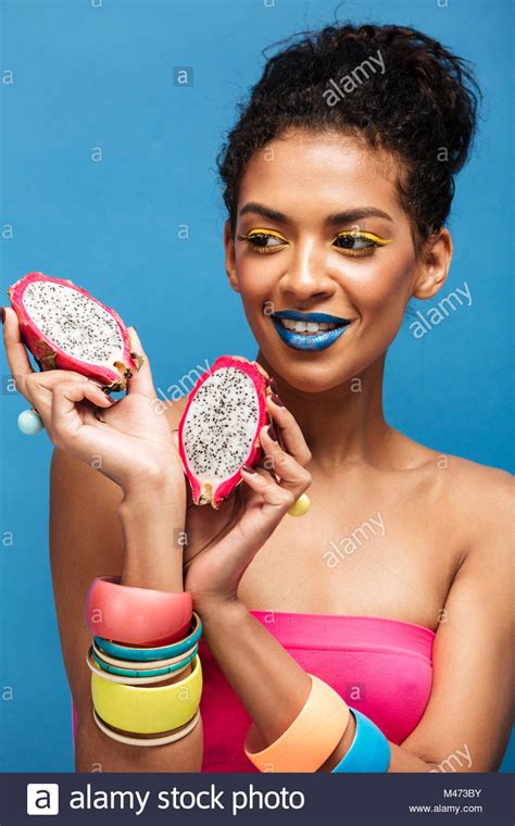 Portrait Of Smiling Mulatto Woman With Bright Cosmetics On Face Tasting