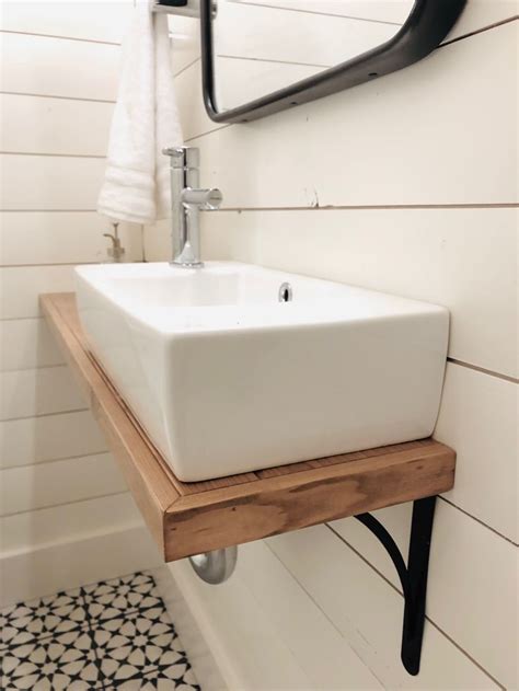 wall mounted sink  custom shelf  shiplap walls small bathroom