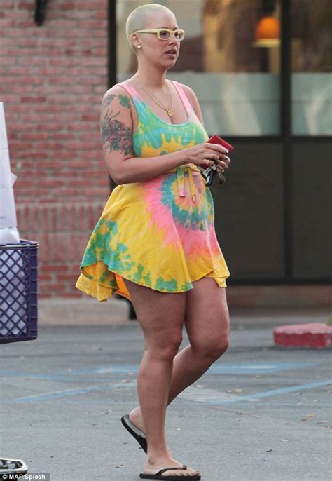 amber rose reveals her post pregnancy curves in a low cut red dress