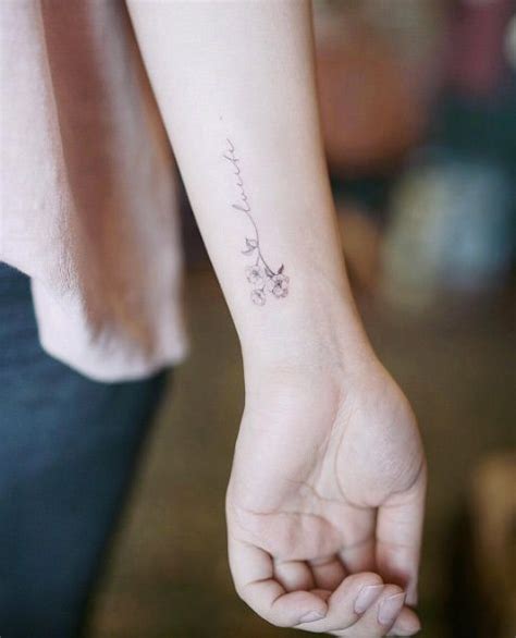 ex libris mini floral wrist tattoo by nando tatuagem