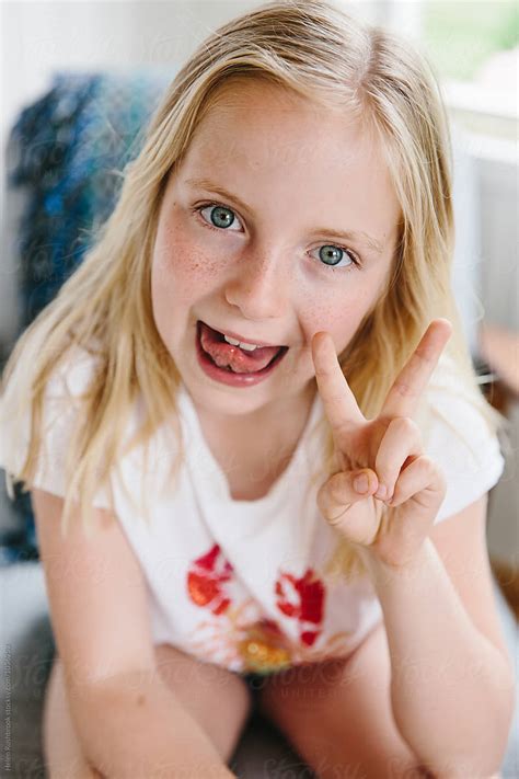 girl sticking  tongue   making  peace sign