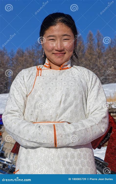 Mongolian Woman Smiling At The Camera In Winter Landscape Editorial