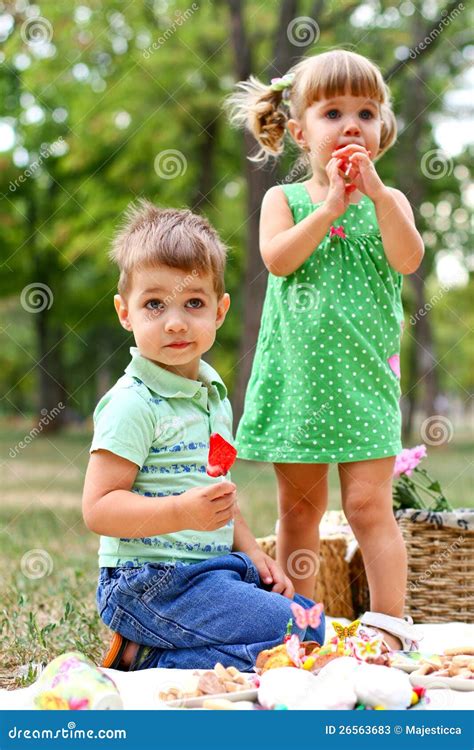 caucasian  boy  girl eating sweets stock  image