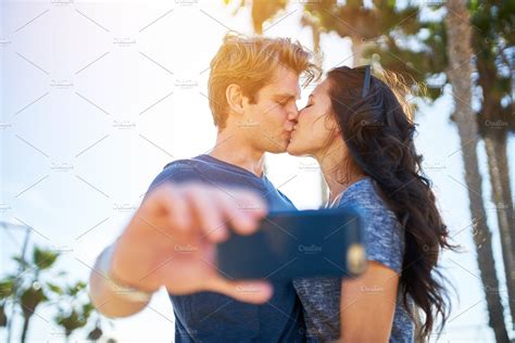 kissing couple taking selfie high quality people images