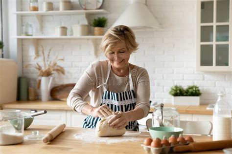 Happy Beautiful Older Woman Preparing Homemade Pastry Stock Image