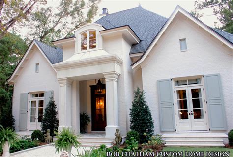 beautiful french cottage design   elegantly detailed entrance  features mahogany