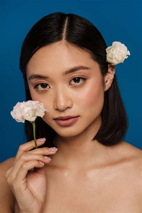 Young Beautiful Asian Woman With Opened Mouth Holding White Flower