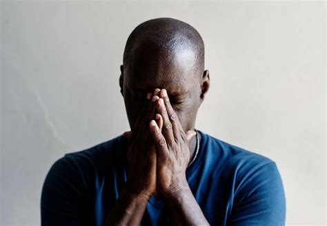 black man  hands covered  face feeling worried id
