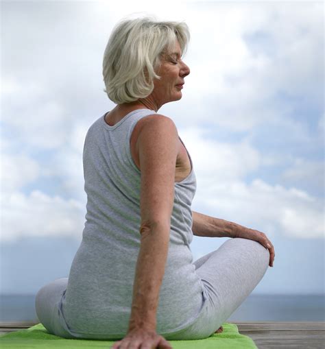 senior woman  yoga outdoors aw health care