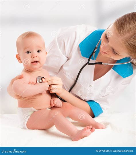 baby  doctor pediatrician doctor listens   heart   stock
