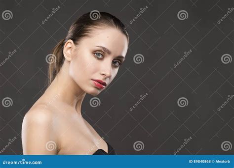 The Beautiful Girl Naked Shoulders Portrait On A Gray Background Stock