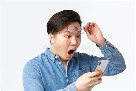 Close Up Of Shocked Asian Man Take Off Glasses Gasping In Awe While