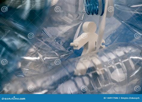 Abstract Model Of Alive Man Stuck Between Plastic Bottle Thrown In A