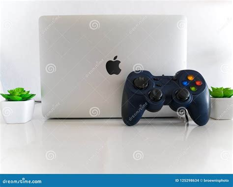 usb gamepad controller attached  apple macbook pro laptop concept editorial stock image