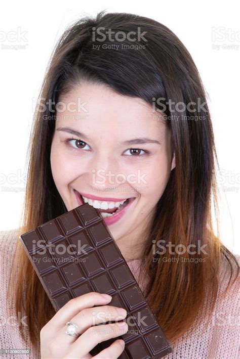Lovely Smiling Teenage Girl Eating Chocolate Isolated On White