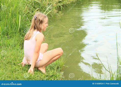 girl watching water  pond stock photo image  child grass