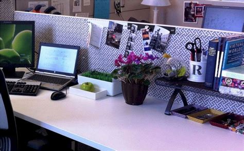 An Office Desk With A Laptop Computer And Flowers On The Top Along