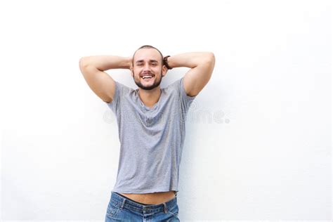 happy young man smiling  hands   head stock photo image  latin confidence