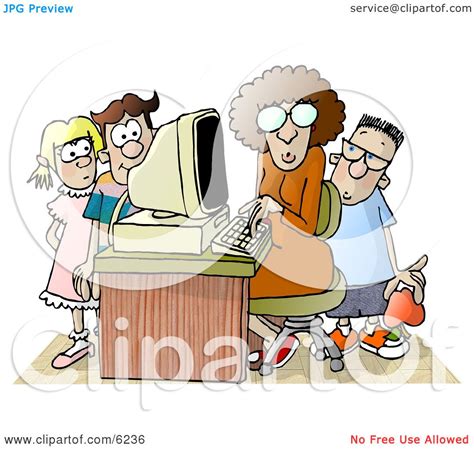 female teacher sitting at a computer surrounded by school