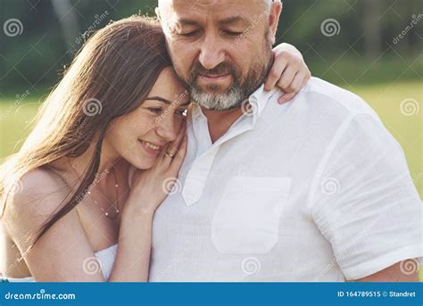 Handsome Old Man And Beautiful Young Girl Are Hugging Daughter And Her