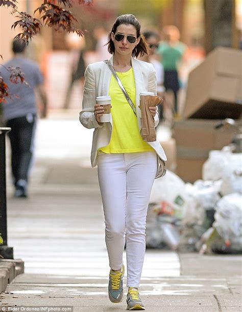 neon clad anne hathaway grabs coffee for two in nyc before