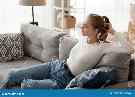Relaxed Young Woman Resting On Comfortable Couch Relaxing Breathing Air