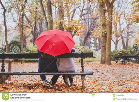 elderly retired couple sitting together on the bench in