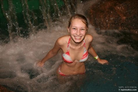 cute solo girl in a bikini flashes her tits at a water park